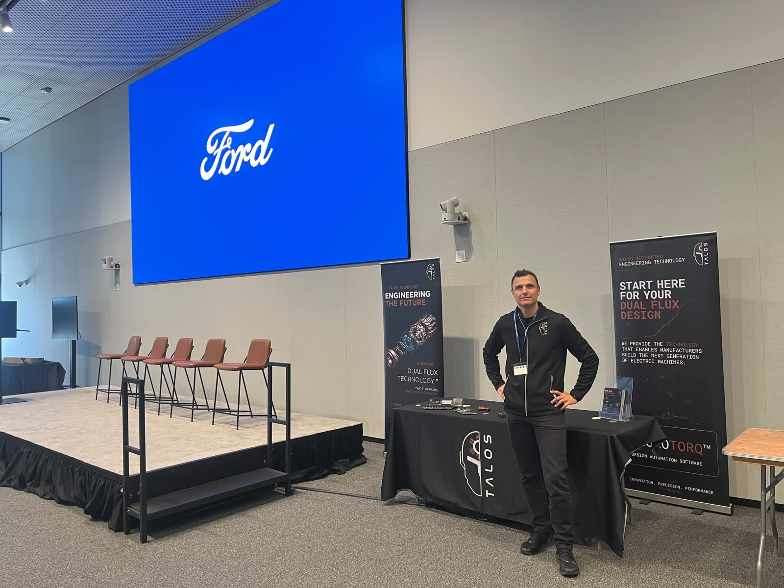 The Talos Technology exhibitor stand in front of the Ford screen at the supplier event at Ford HQ in Dearborn, Michigan