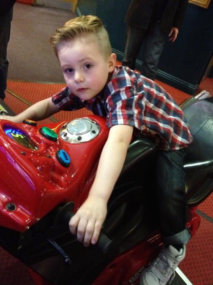 Evan as a child on a toy motorbike